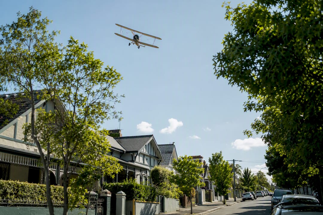 Airplane flying over Sydney suburb houses