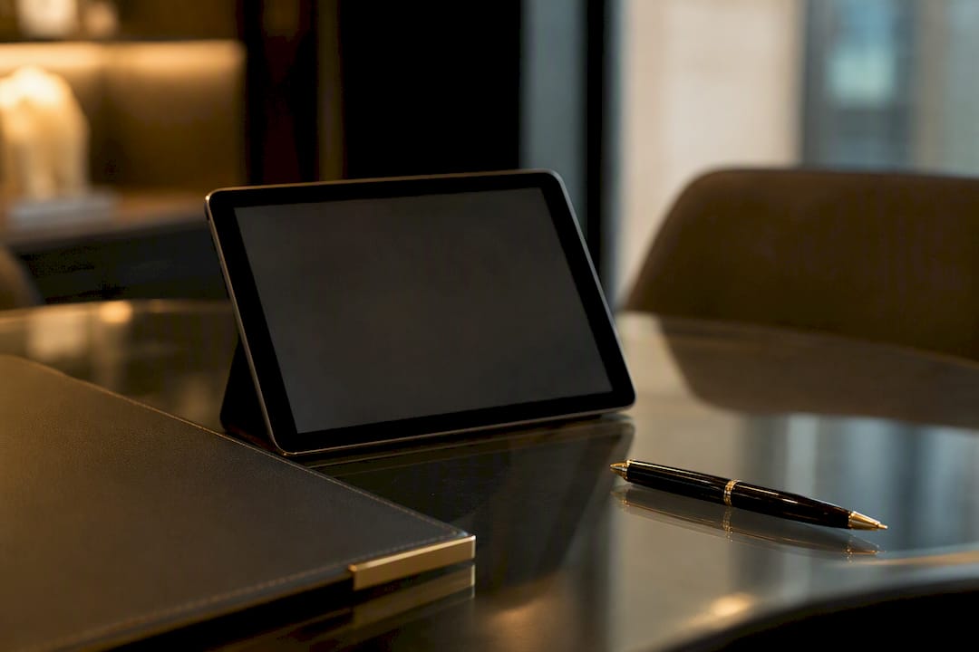 Tablet and agent tools on table with pen and wallet
