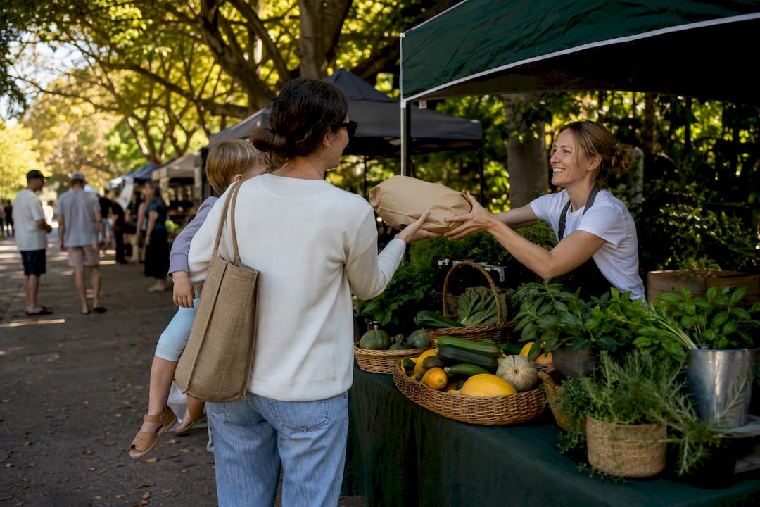 Families browsing a Balmoral community market